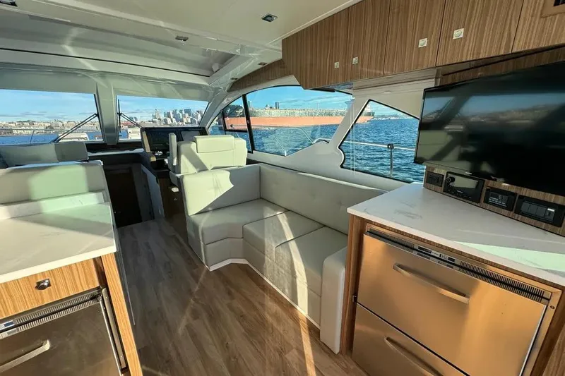 Slide: The Image of Luxurious interior of 2024 Cruisers Yachts 50 Cantius with modern furnishings and scenic water view. - 17