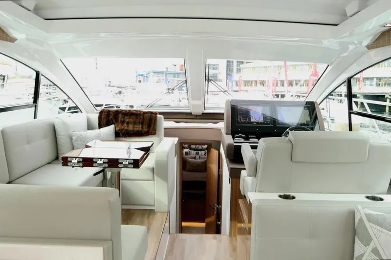 Slide: The Image of Luxurious interior of 2024 Cruisers Yachts 50 Cantius with modern seating and navigation console. - 20