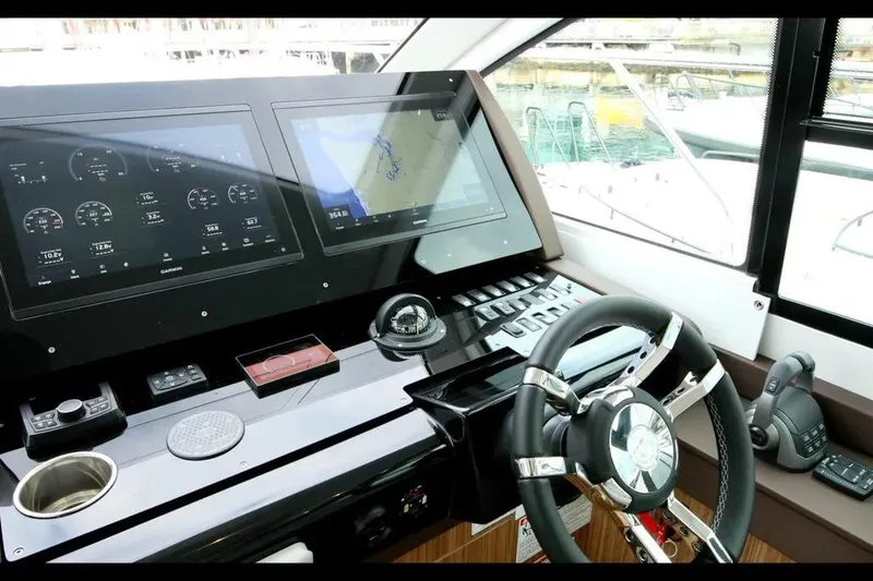 Slide: The Image of 2024 Cruisers Yachts 50 Cantius helm with advanced navigation displays and controls. - 23