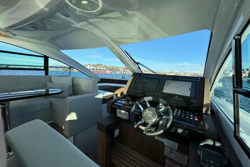 Slide: The Image of 2024 Cruisers Yachts 50 Cantius helm with modern navigation system and luxurious seating. - 29