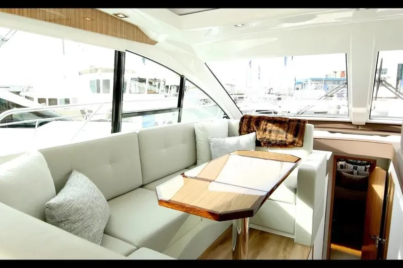 Slide: The Image of Luxurious interior of 2024 Cruisers Yachts 50 Cantius with elegant seating and panoramic windows. - 30