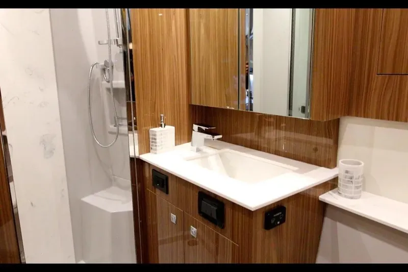 Slide: The Image of Luxurious bathroom in 2024 Cruisers Yachts 50 Cantius with modern fixtures and wood accents. - 34