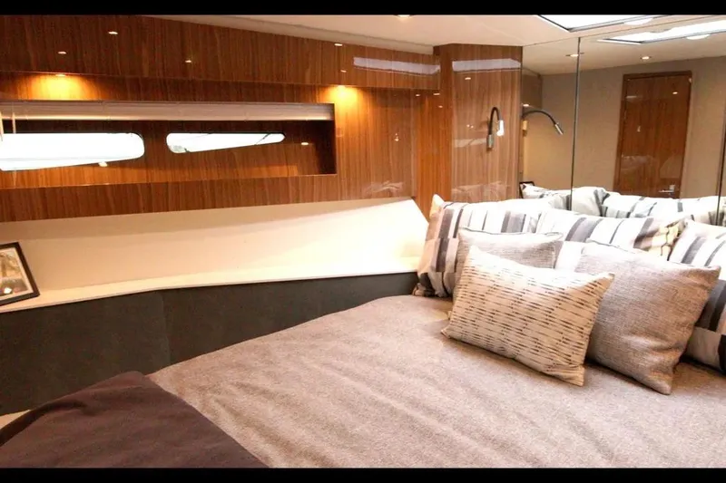 Slide: The Image of Luxurious 2024 Cruisers Yachts 50 Cantius bedroom with elegant wood paneling and plush bedding. - 35