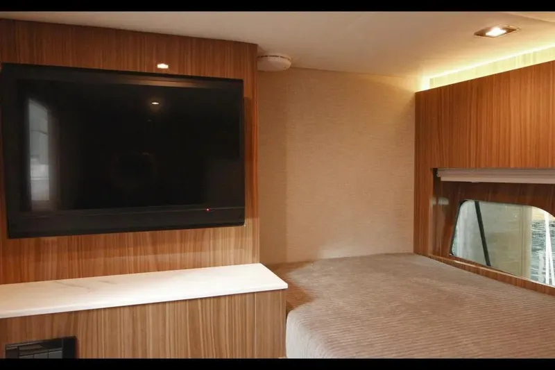 Slide: The Image of Luxurious interior of 2024 Cruisers Yachts 50 Cantius with TV and cozy bed. - 39