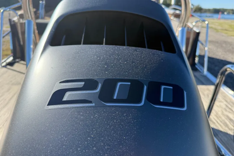 Slide: The Image of 2026 Avalon Catalina Cruise Rear Bench Windshield with "200" emblem, close-up view. - 3