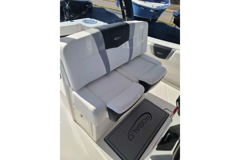 Slide: The Image of 2023 Robalo R270 Center Console boat seating with logo, featuring white and gray upholstery. - 11