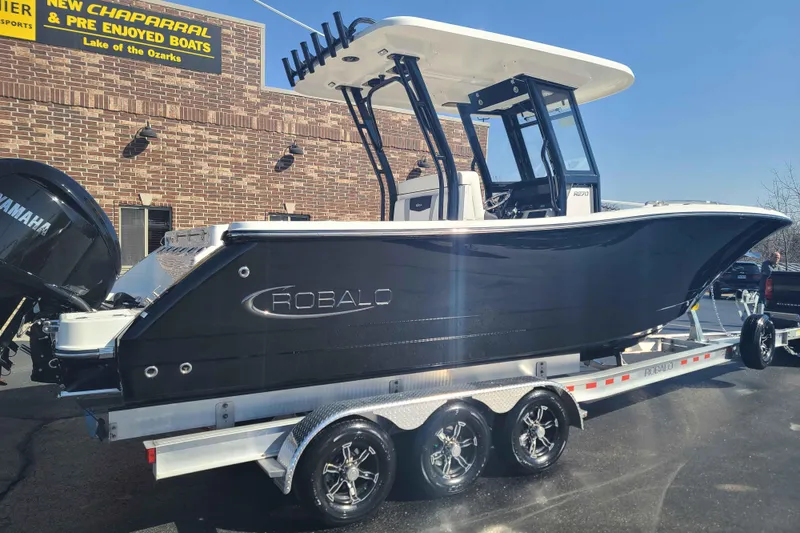 Slide: The Image of 2023 Robalo R270 Center Console boat on trailer, displayed outdoors. - 4