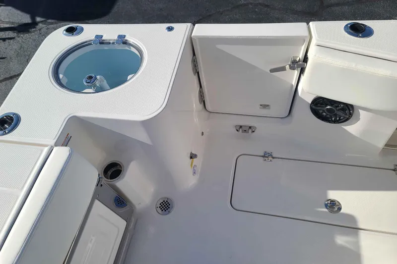Slide: The Image of 2023 Robalo R270 Center Console boat interior with storage compartments and livewell. - 5