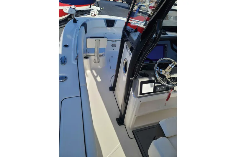 Slide: The Image of 2023 Robalo R270 Center Console boat interior with steering wheel and control panel. - 9