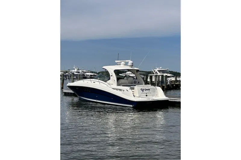 Slide: The Image of 2008 Sea Ray 40 Sundancer yacht docked at marina under clear sky. - 1