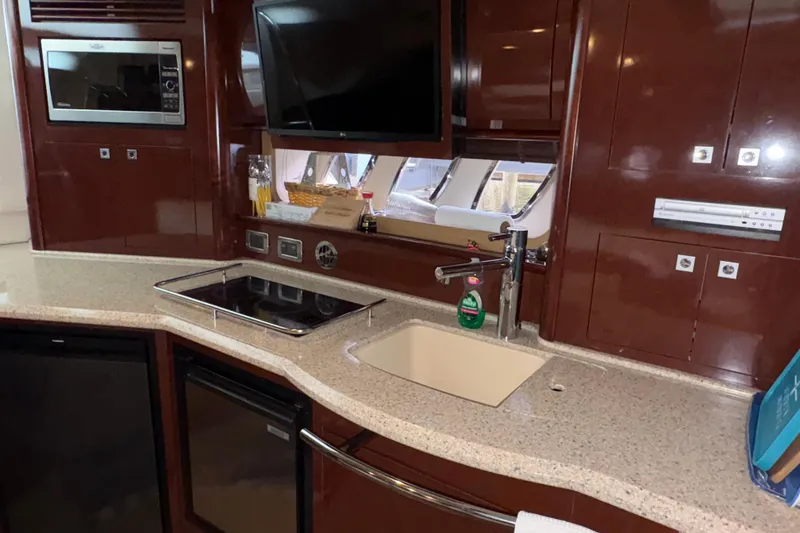 Slide: The Image of Luxurious kitchen area in a 2008 Sea Ray 40 Sundancer yacht with modern amenities. - 12