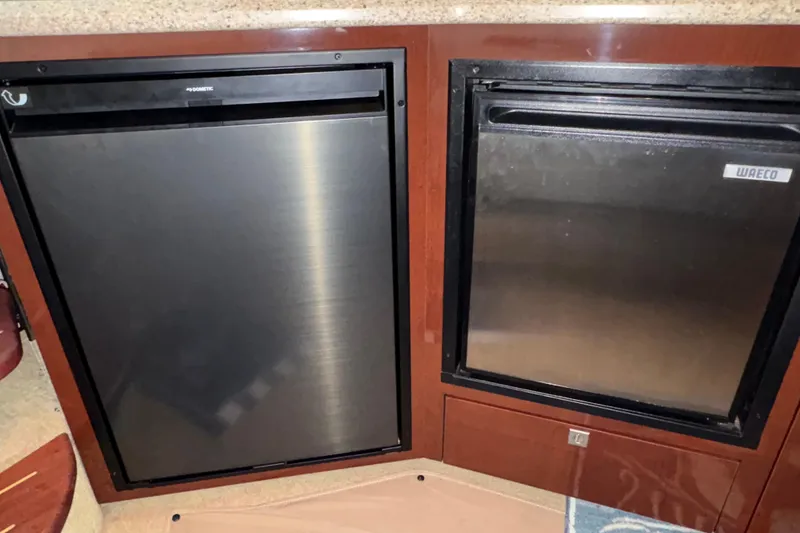 Slide: The Image of 2008 Sea Ray 40 Sundancer galley with Dometic and Waeco refrigerators. - 13