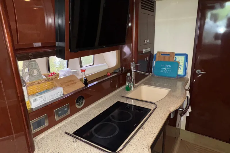 Slide: The Image of Luxurious kitchen interior of 2008 Sea Ray 40 Sundancer yacht with modern amenities. - 14