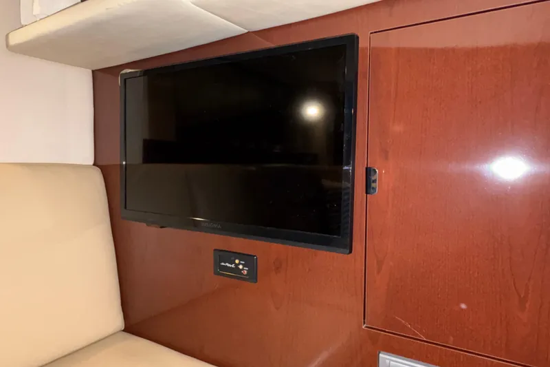 Slide: The Image of Flat-screen TV in 2008 Sea Ray 40 Sundancer yacht interior with wood paneling. - 18