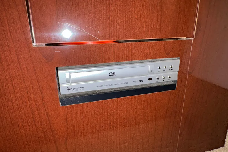 Slide: The Image of DVD player in 2008 Sea Ray 40 Sundancer yacht interior, wooden paneling. - 19
