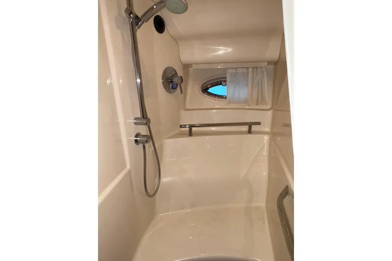 Slide: The Image of Shower area in 2008 Sea Ray 40 Sundancer yacht with chrome fixtures and porthole window. - 21