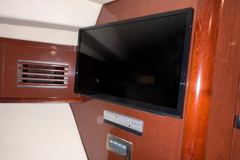 Slide: The Image of Flat-screen TV in 2008 Sea Ray 40 Sundancer yacht interior with wood paneling. - 23