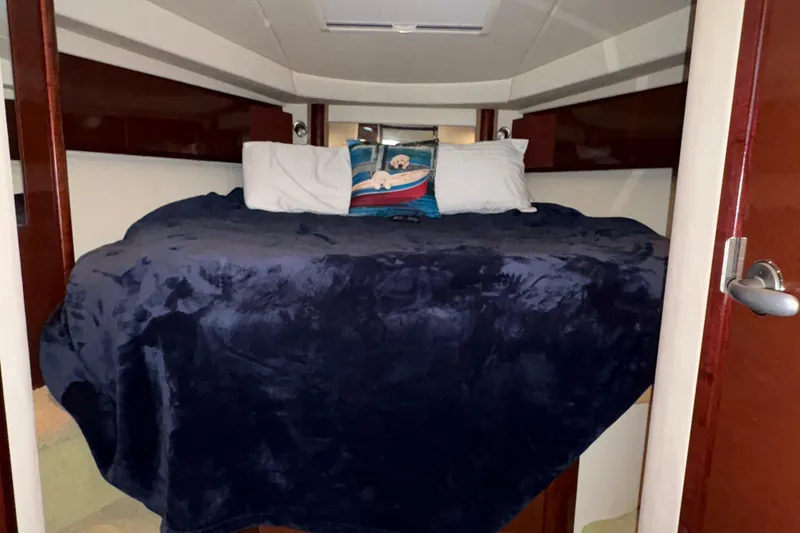 Slide: The Image of Cozy cabin interior of 2008 Sea Ray 40 Sundancer with plush bedding. - 24