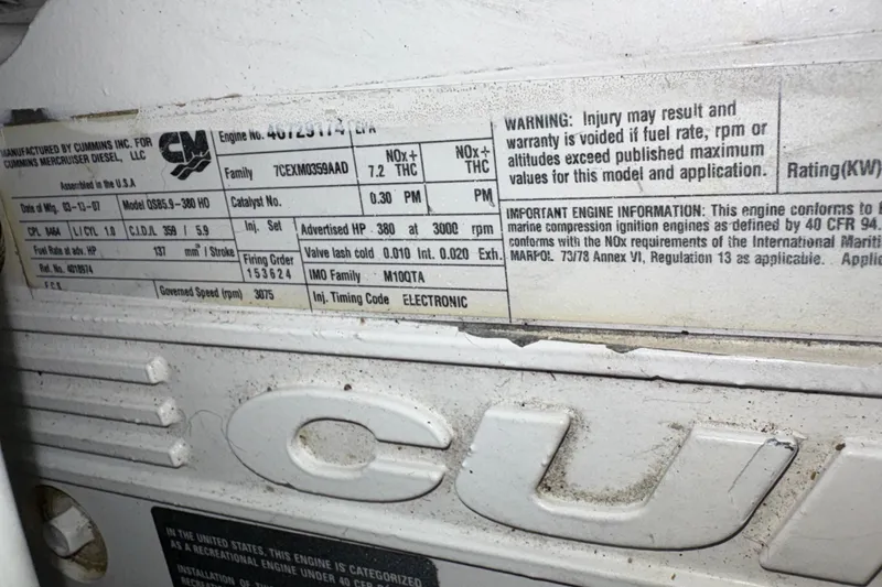 Slide: The Image of Label on Cummins engine for 2008 Sea Ray 40 Sundancer, detailing specifications and warnings. - 27