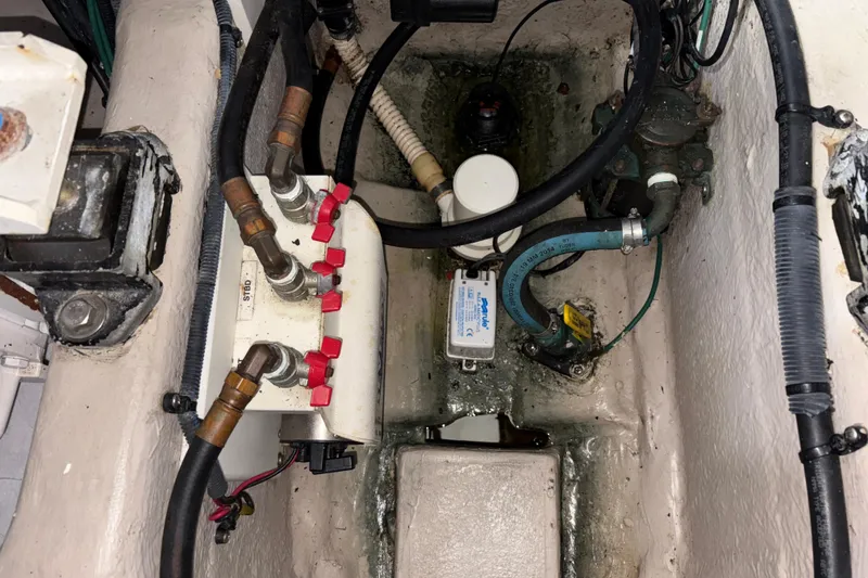 Slide: The Image of Engine compartment of a 2008 Sea Ray 40 Sundancer with visible hoses and components. - 30