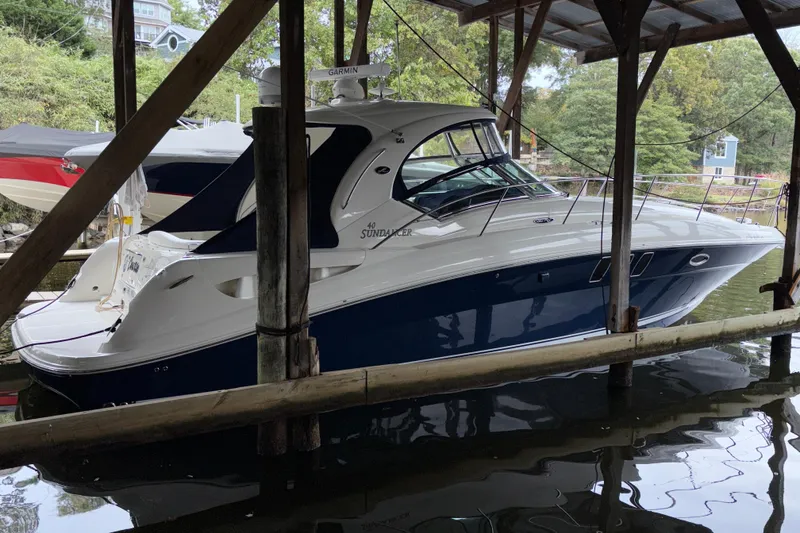 Slide: The Image of 2008 Sea Ray 40 Sundancer yacht docked under a covered marina, side view. - 34