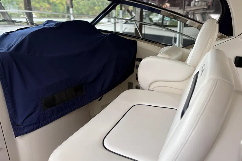 Slide: The Image of Interior of 2008 Sea Ray 40 Sundancer with white seating and covered controls. - 5