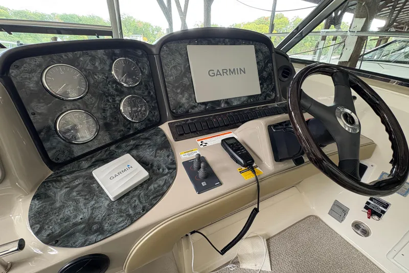 Slide: The Image of 2008 Sea Ray 40 Sundancer helm with Garmin navigation system and steering wheel. - 6