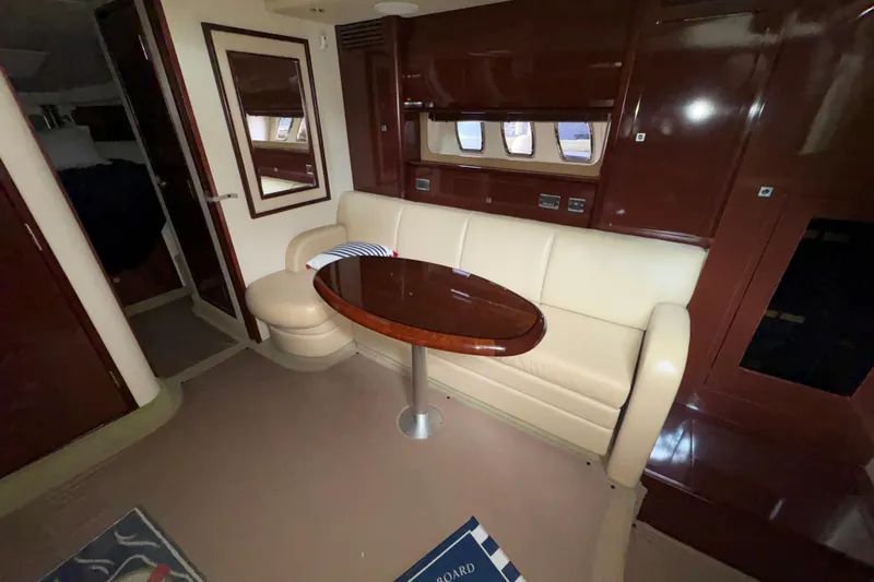 Slide: The Image of 2008 Sea Ray 40 Sundancer interior with cream leather seating and wooden table. - 7