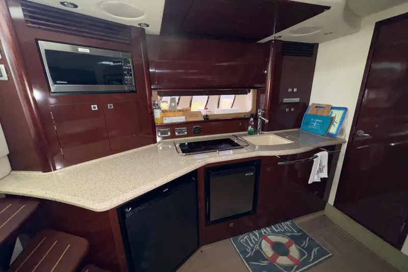 Slide: The Image of Luxurious 2008 Sea Ray 40 Sundancer yacht kitchen with modern amenities and sleek design. - 8