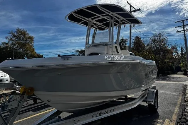 The Image of 2024 Robalo R180 Center Console boat interior with steering wheel and rod holders. - 0