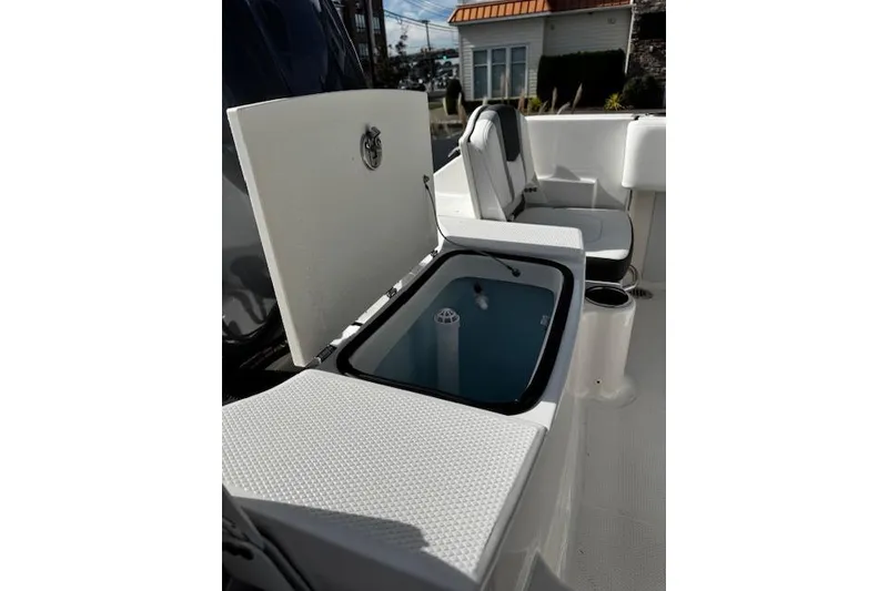 Slide: The Image of 2024 Robalo R180 Center Console boat interior with open storage compartment. - 15