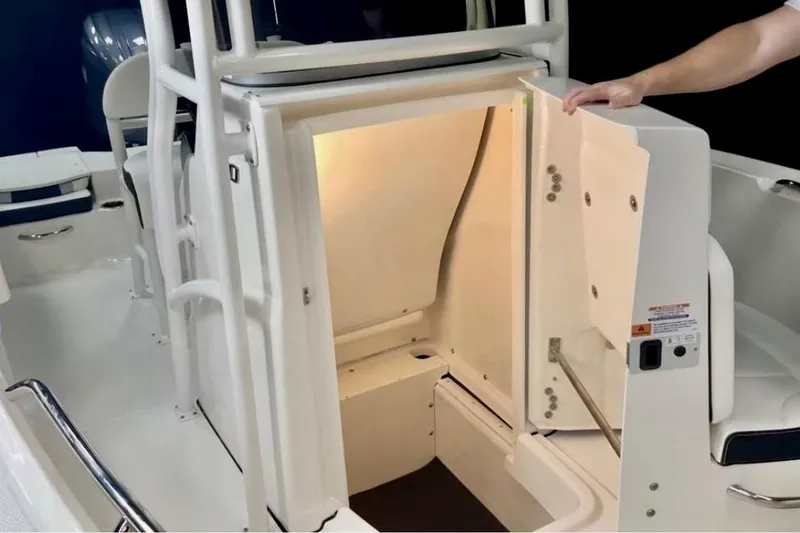 Slide: The Image of 2024 Robalo R180 Center Console boat interior with open storage compartment. - 18