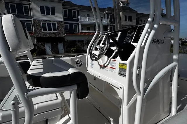 Slide: The Image of 2024 Robalo R180 Center Console boat at Seaport Inlet Marina, full-service dealer sign visible. - 7
