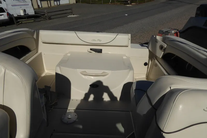 Slide: The Image of 2004 Sea Ray 225 Weekender boat interior with seating and storage area. - 10