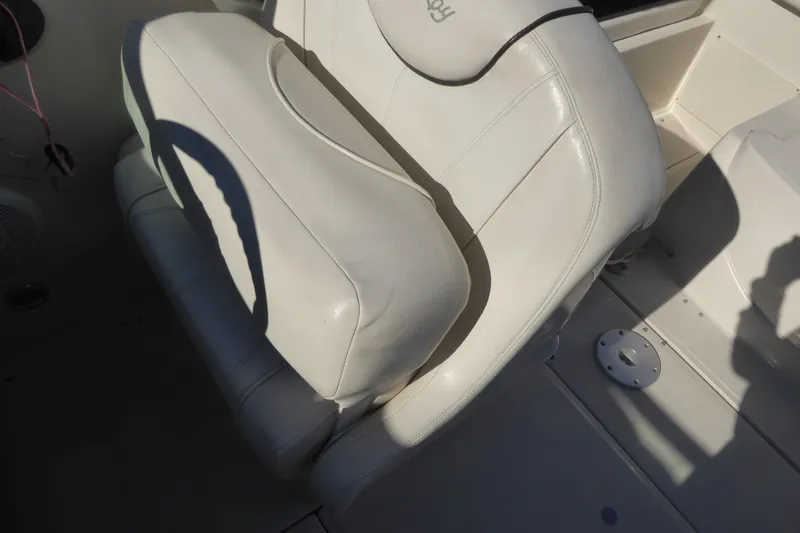 Slide: The Image of White leather seat on 2004 Sea Ray 225 Weekender boat, with shadow and floor details. - 13