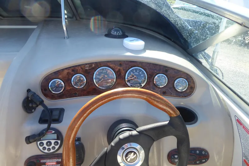 Slide: The Image of Dashboard of a 2004 Sea Ray 225 Weekender boat with wooden steering wheel. - 17