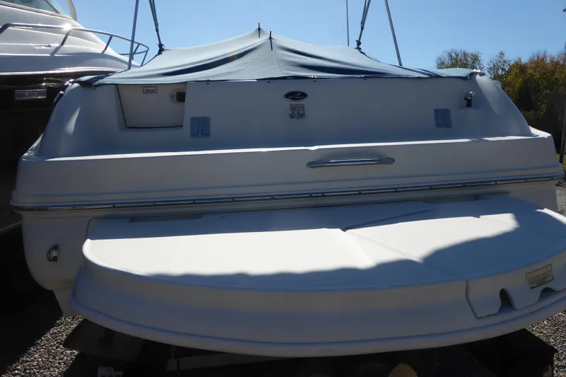 Slide: The Image of 2004 Sea Ray 225 Weekender boat with cover, rear view in sunlight. - 21