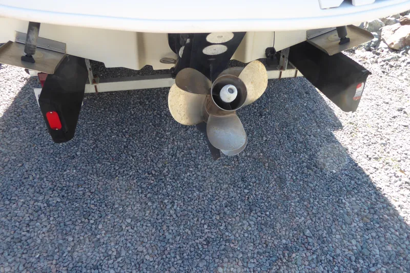 Slide: The Image of Rear view of 2004 Sea Ray 225 Weekender boat propeller on gravel. - 22