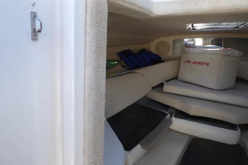 Slide: The Image of 2004 Sea Ray 225 Weekender cabin interior with life jackets and seating. - 28