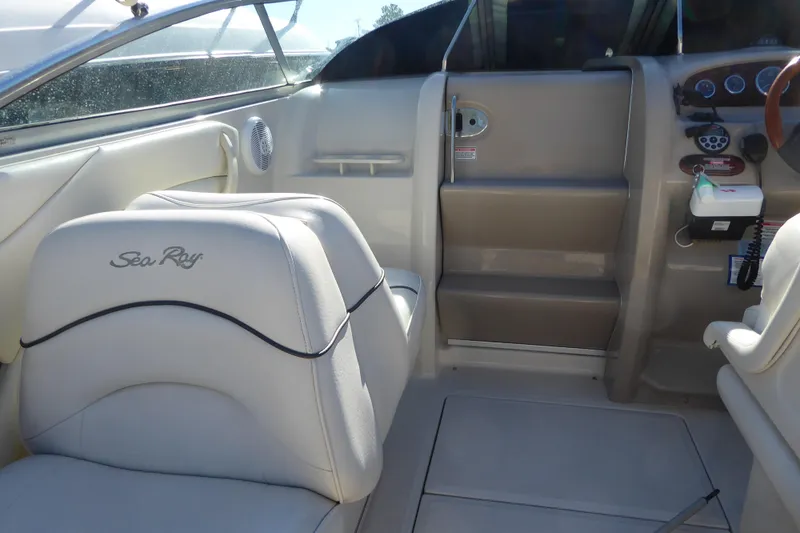 Slide: The Image of Interior of a 2004 Sea Ray 225 Weekender boat, featuring seating and control panel. - 5