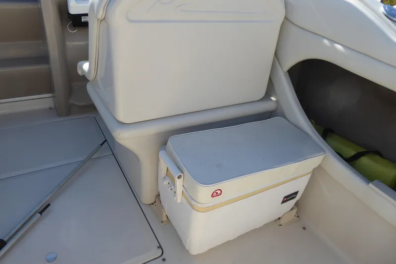 Slide: The Image of 2004 Sea Ray 225 Weekender interior with seating and storage area. - 6