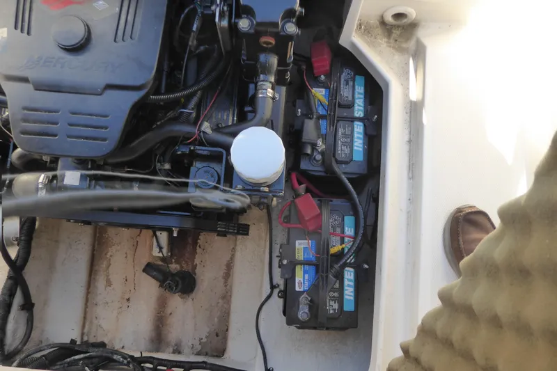 Slide: The Image of Engine compartment of a 2004 Sea Ray 225 Weekender with visible batteries and wiring. - 8