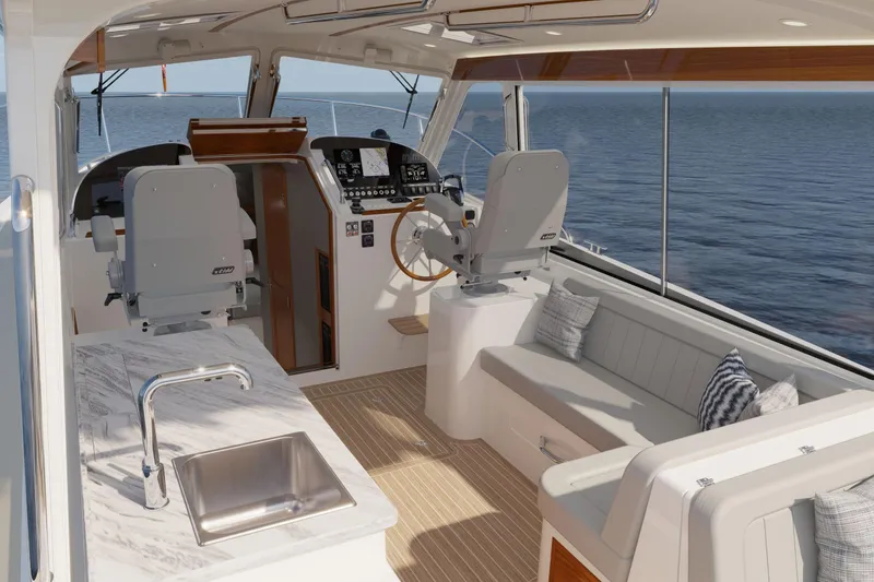 Slide: The Image of Luxurious interior of 2026 MJM 38R yacht with seating, helm, and kitchenette. - 13