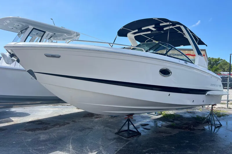 The Image of 2025 Chaparral 270 OSX boat on display, featuring sleek white design and modern features. - 0