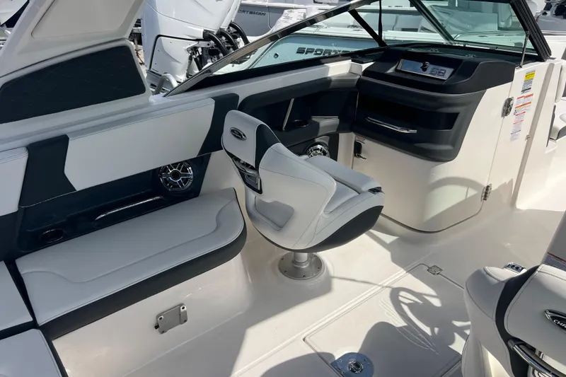Slide: The Image of 2025 Chaparral 270 OSX boat interior with modern seating and dashboard design. - 11