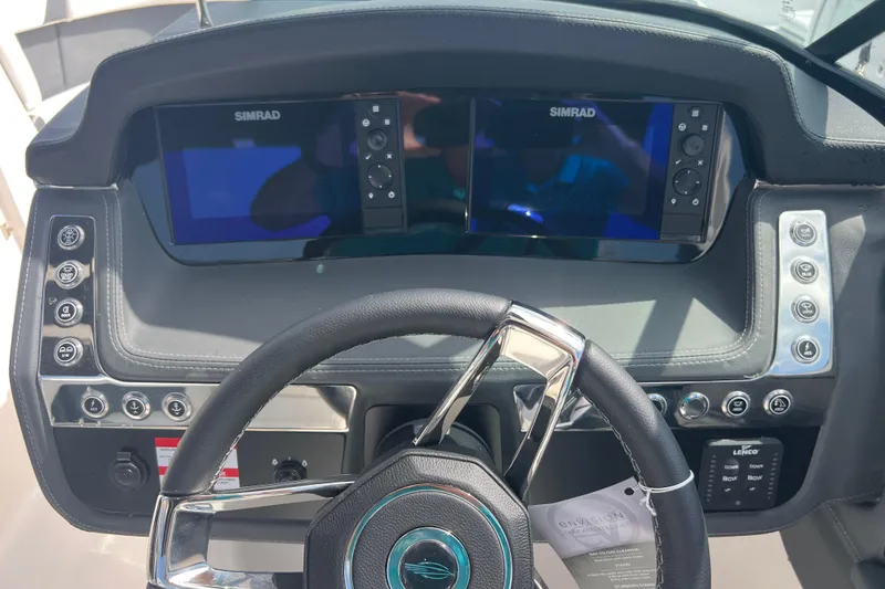 Slide: The Image of 2025 Chaparral 270 OSX dashboard with dual Simrad displays and modern steering wheel. - 14