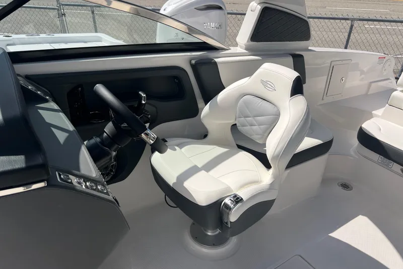 Slide: The Image of 2025 Chaparral 270 OSX boat interior with modern steering and luxurious seating. - 21