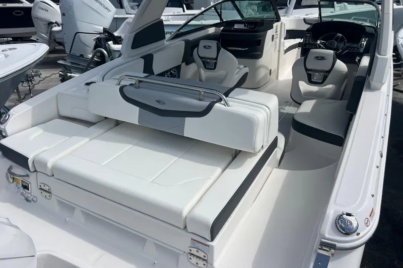 Slide: The Image of 2025 Chaparral 270 OSX boat interior with luxurious seating and modern dashboard. - 7