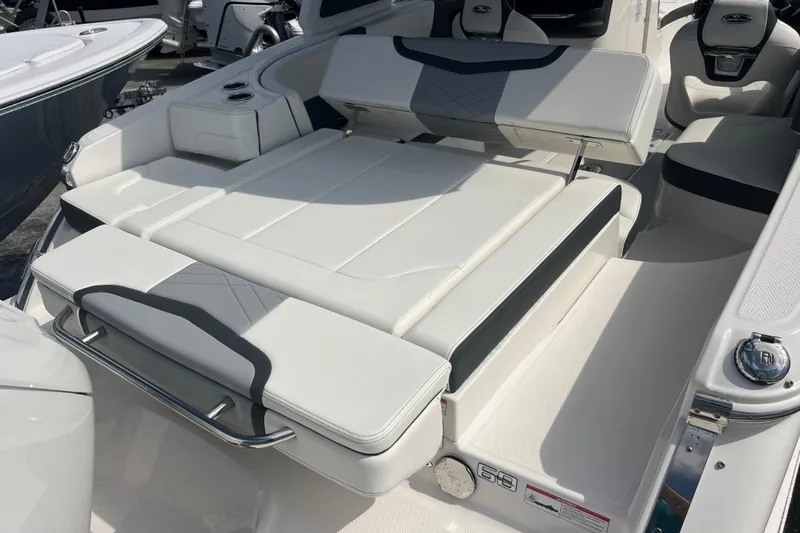 Slide: The Image of 2025 Chaparral 270 OSX boat interior with luxurious white seating and modern design. - 8