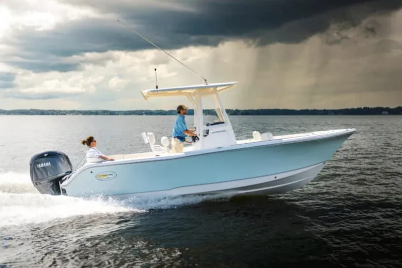 Slide: The Image of Manufacturer Provided Image: 2026 Sea Hunt Ultra 229 boat cruising on a lake under cloudy skies. - 0